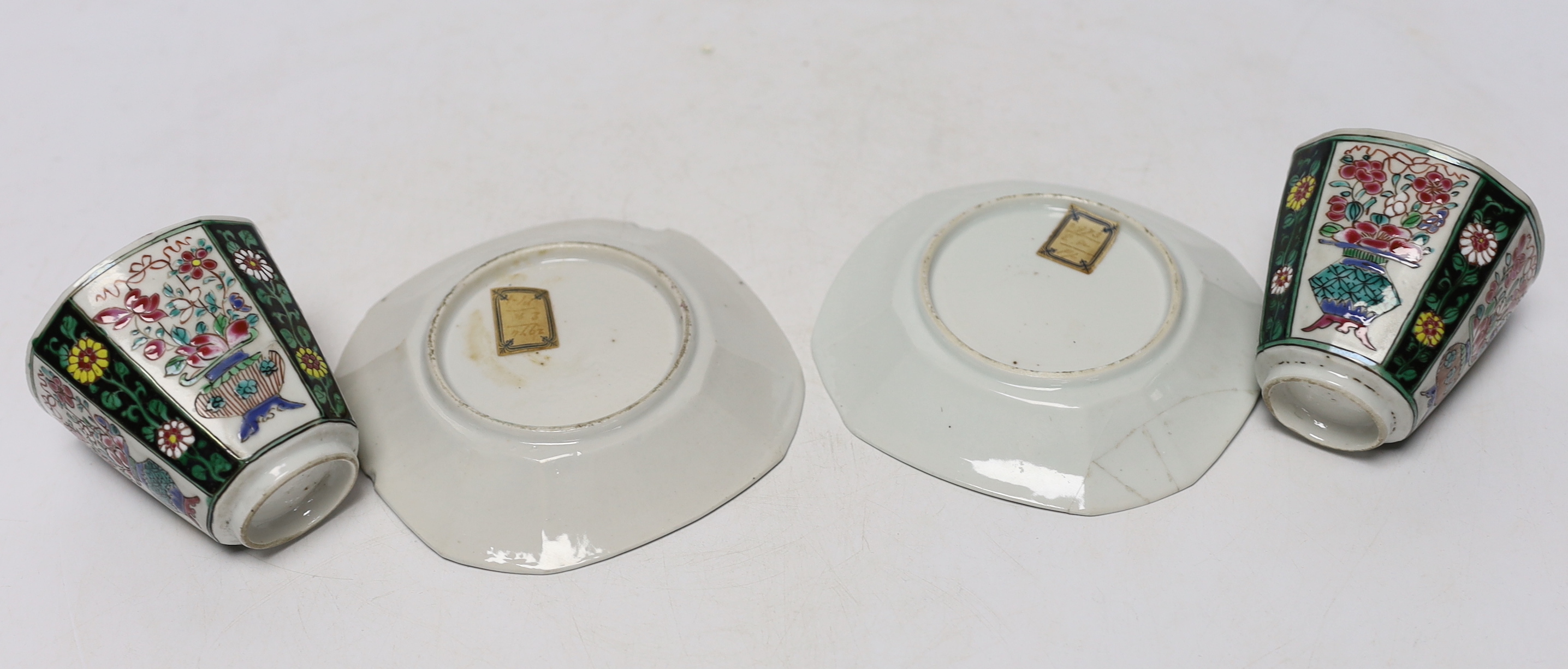A pair of Chinese Qianlong famille rose octagonal cups and saucers, with panelled floral decoration, saucers 12cm cups height 6.5cm diameter 6.75cm